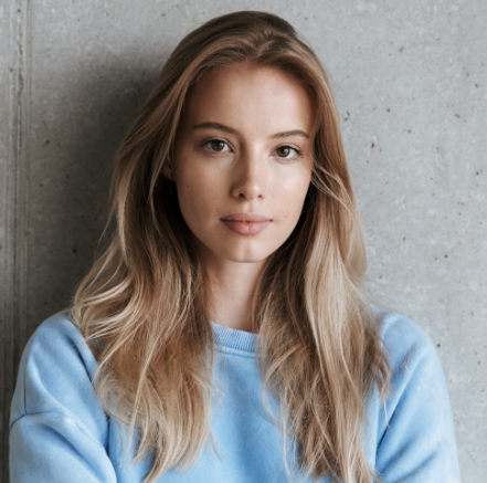 pretty-woman-standing-over-grey-wall-background-4A829TX