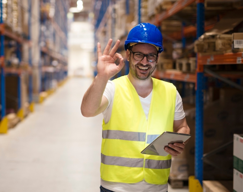 warehouse-worker-standing-large-storage-center-showing-ok-hand-gesture-satisfied-delivering-goods